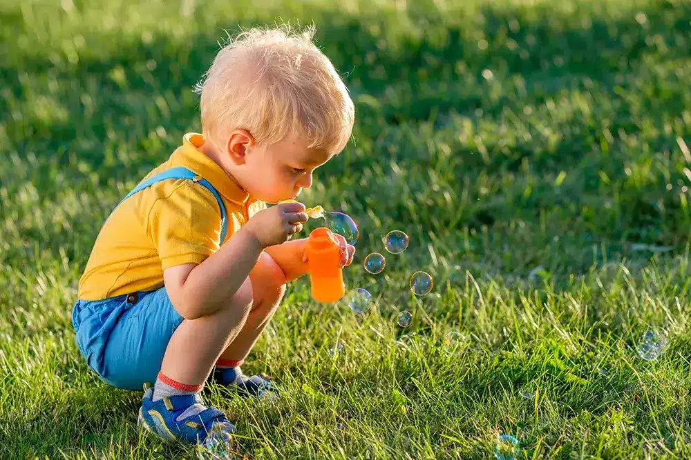 child blowing bubbles